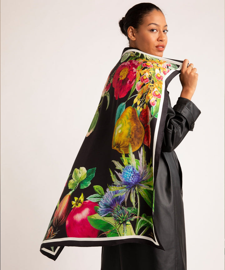 Model wearing A Snail's Tale 35" Silk Scarf in Black over a black trenchcoat