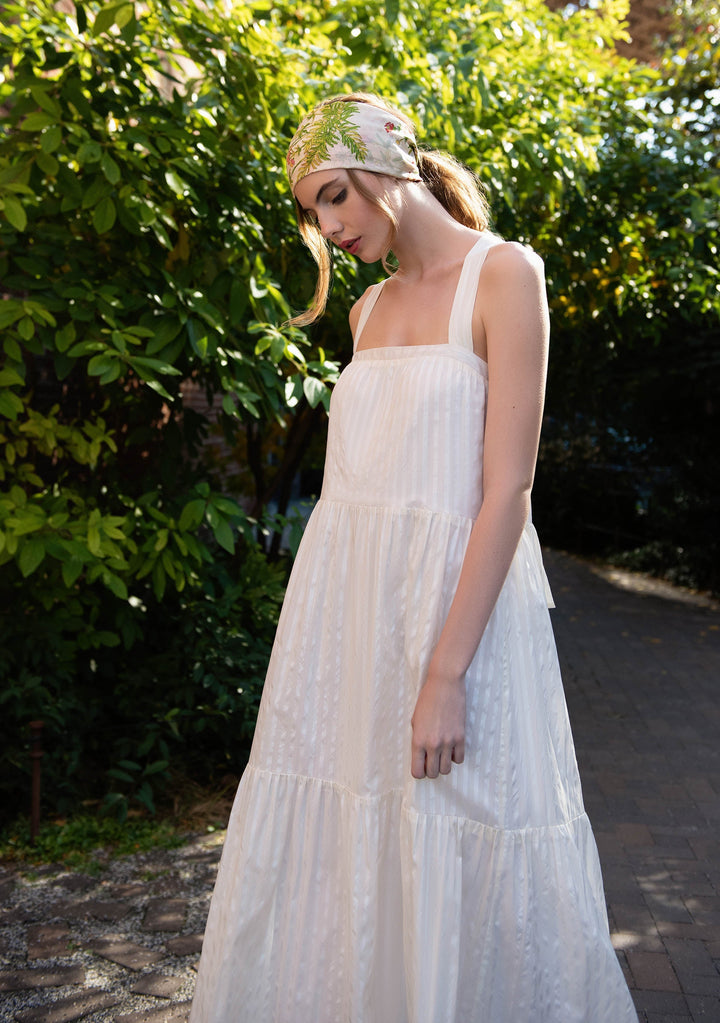 woman outside wearing white sleeveless cotton silk blend dress