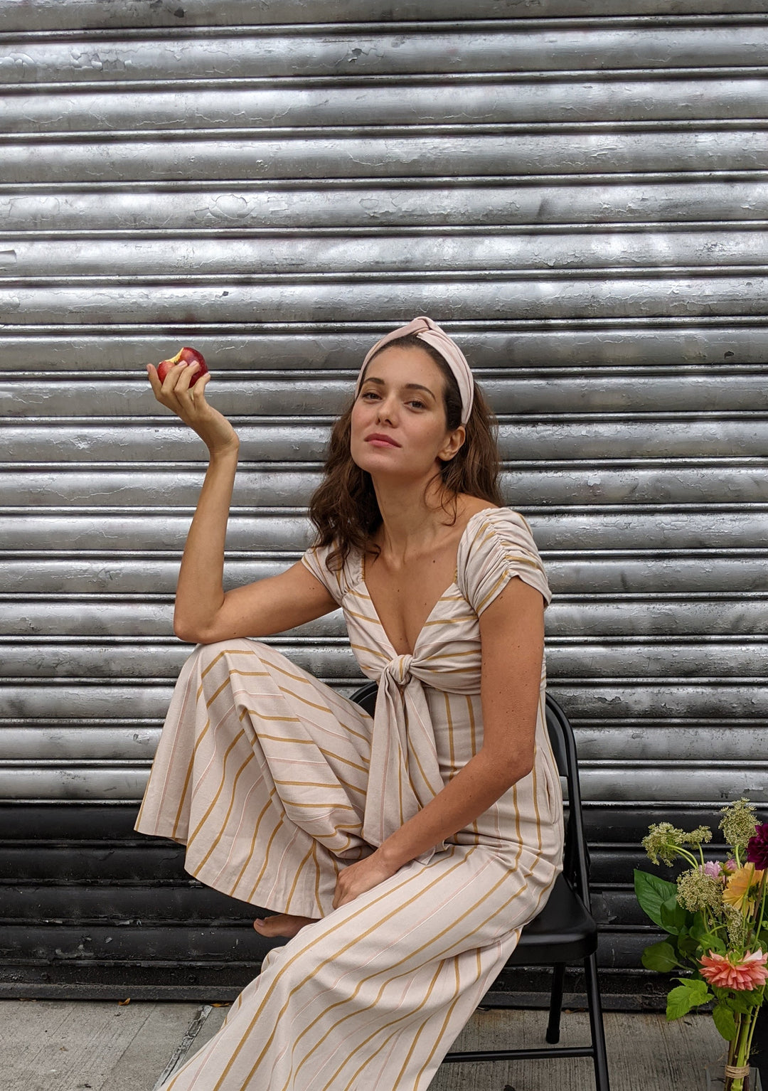 woman sitting wearing pink silk headband multi stripe